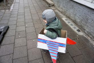 
		Child in a self-made airplane costume
	